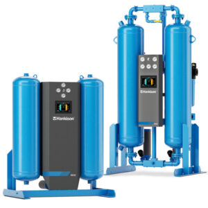 Two blue "Hankison" HHL/HHS/HHE Series heatless desiccant dryers with control panels, standing side by side.