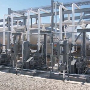 Liquid Transfer Solutions equipment with pipes, panels, and tanks installed outdoors on a gravel surface.